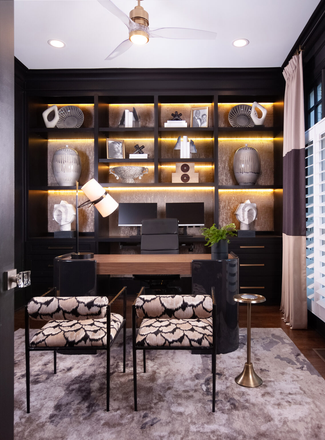 Sophisticated office with dark shelving